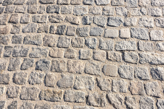 Cobblestone road macro texture background taken during golden hour in historic Shockoe Bottom, Richmond, Virginia.
