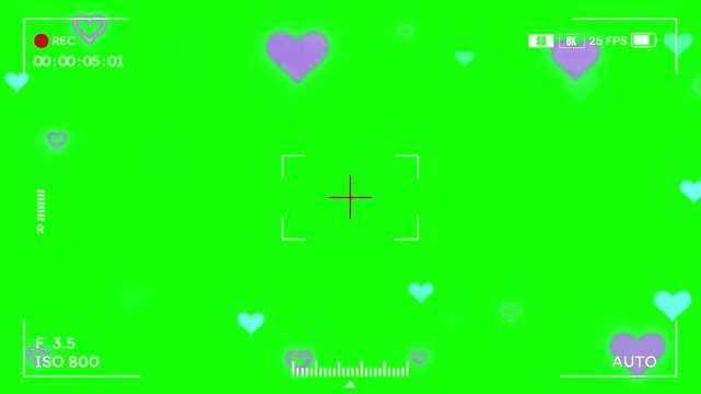 Camera viewfinder displays a digital interface with floating hearts to capture romantic moments for creative video production.