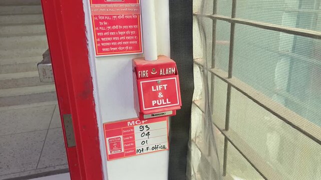 Red Manual Fire Alarm Call Point and Pull Station on Building Wall
