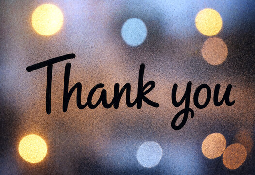 Beautiful thank you message with artistic handwritten font and soft bokeh lights background