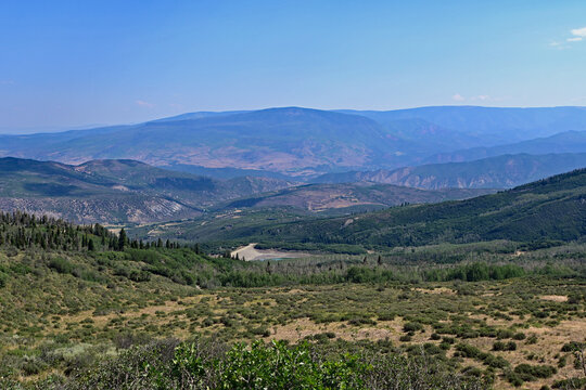 View of Roaring Fork Valley from Thomas Lakes Trail on clear sunny summer morning.