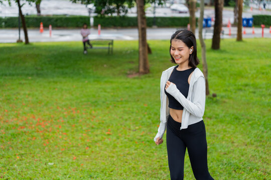 Asian sporty woman running in public park