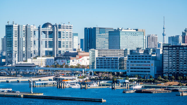 Scenic view of Odaiba island skyline with Fuji TV tower and Tokyo Plaza mall with Skytree in background in Odaiba Tokyo Japan