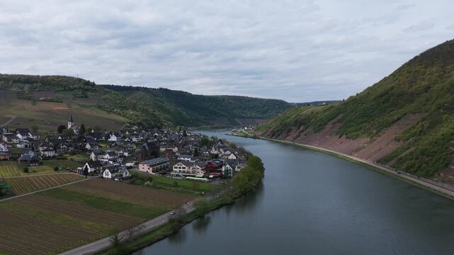 Historic town of Cochem situated along wide Moselle river in Germany. Aerial forward, copy space