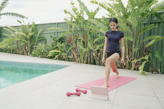 Teenage Girl Practicing Yoga Outside by the Pool, Fitness Lifestyle