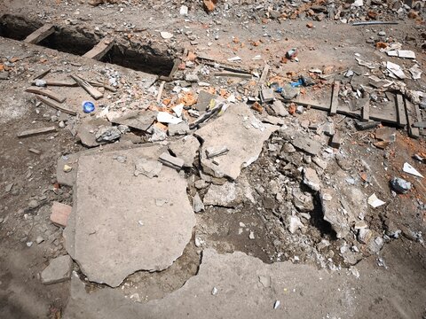 Damaged concrete ground and rubble on construction site during daylight