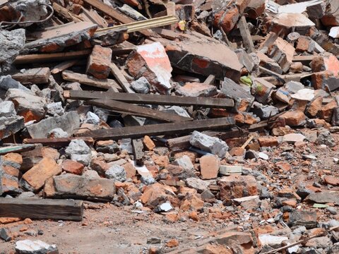 Pile of broken bricks and wooden beams at a construction demolition site