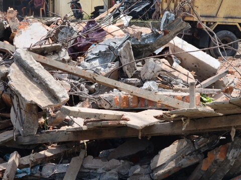 Pile of concrete rubble and twisted steel from a demolished building