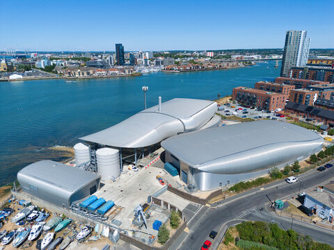 Aerial view of the Woolston Water Treatment Plant featuring modern curved metallic structures and industrial tanks situated along the waterfront in Southampton, England, United Kingdom.