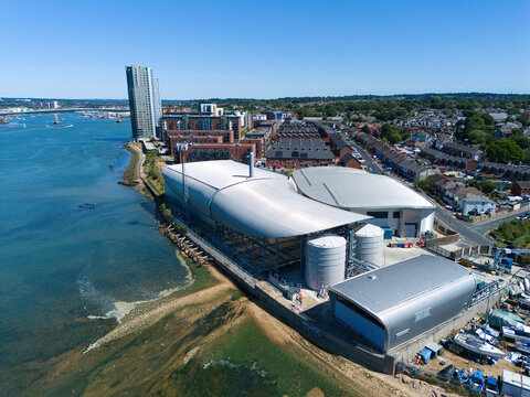 Aerial view of Woolston Water Treatment Plant with modern industrial buildings, storage tanks, and nearby residential areas along the River Itchen in Southampton, England, United Kingdom.