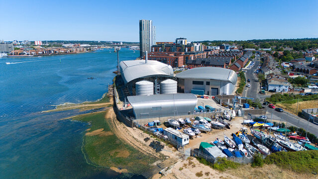 Aerial view of the Woolston Water Treatment Plant with its modern curved metallic structures and adjacent boat storage yard along the River Itchen in Southampton, England, United Kingdom.