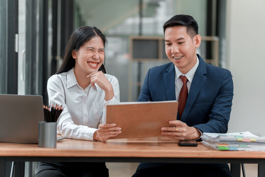 Business Meeting with Female and Male Colleagues Discussing Documents at Office Desk