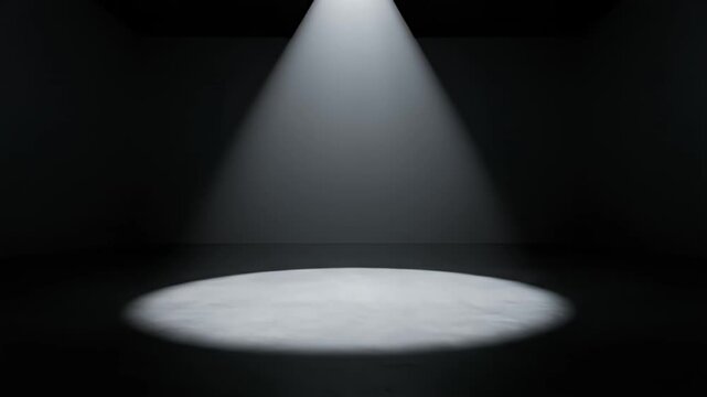 Bright circular spotlight on floor in dark room.
