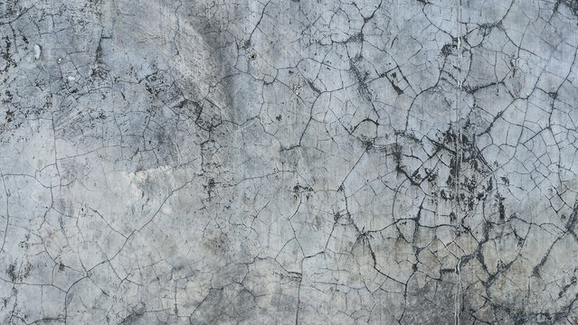 Texture concrete wall of light grey color cement texture background.Grey pastel rough crack cement texture stone concrete,rock plastered stucco wall; painted flat fade background. Side view, front.
