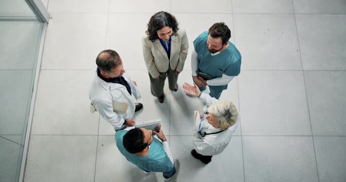 Handshake, above and team of doctors in hospital with medical deal, agreement or partnership. Collaboration, people and healthcare employees shaking hands with director for support in clinic.