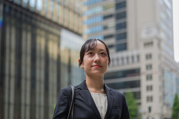 Fototapeta premium 自信のある表情で前を見つめる丸の内の若いビジネスウーマン