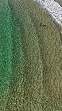 Aerial View of Person Standing in Turquoise Ocean Water