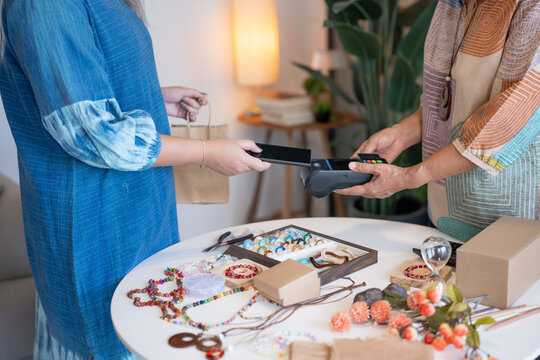 woman using smartphone for contactless payment with EDC payment representing digital finance and cashless technology adoption