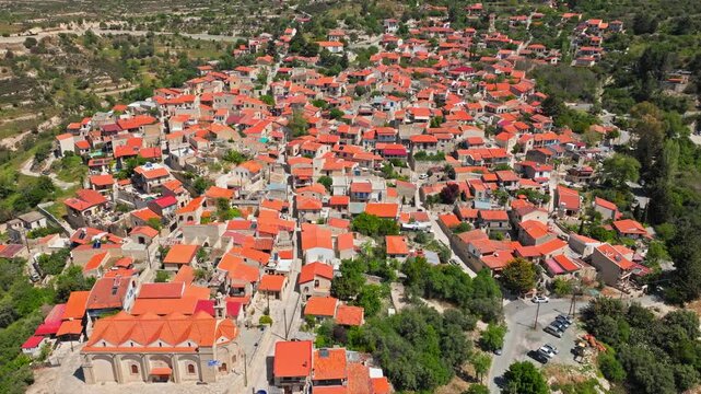 Drone view of Omodos village in the Troodos foothills. Dense red rooftops, traditional architecture and mountain scenery create a classic Cypriot village view.