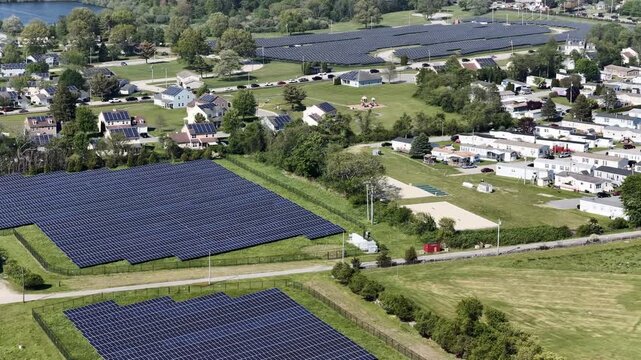Aerial view of solar farm beside a residential neighborhood in Portsmouth, Rhode Island, USA. Sustainable energy. g.