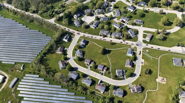 Aerial view of solar farm beside a residential neighborhood in Portsmouth, Rhode Island, USA. Sustainable energy. g.