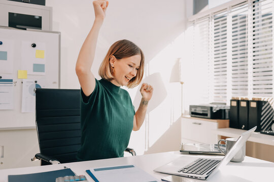 Young beautiful businesswoman works in the office with a laptop. Success