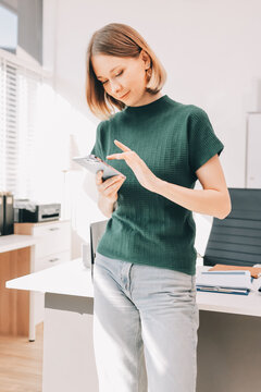 Closeup image of a businesswoman using mobile phone in office