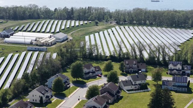 Aerial view of solar farm beside a residential neighborhood in Portsmouth, Rhode Island, USA. Sustainable energy. g.