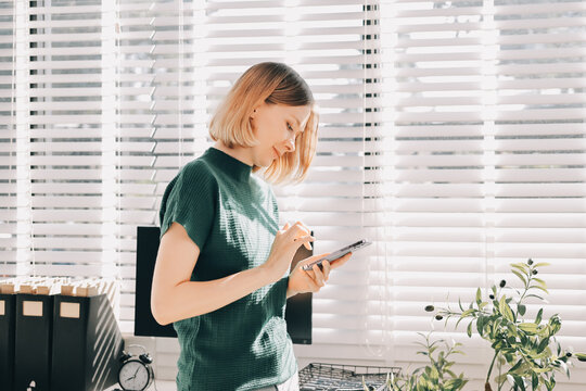 Closeup image of a businesswoman using mobile phone in office