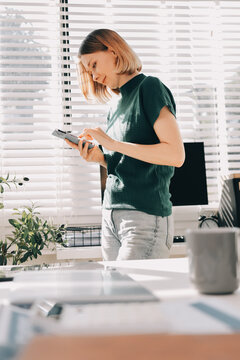 Closeup image of a businesswoman using mobile phone in office