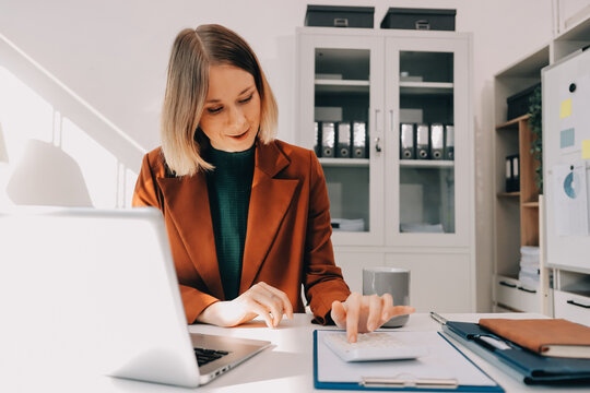 Woman smiling to herself as she works in an office
