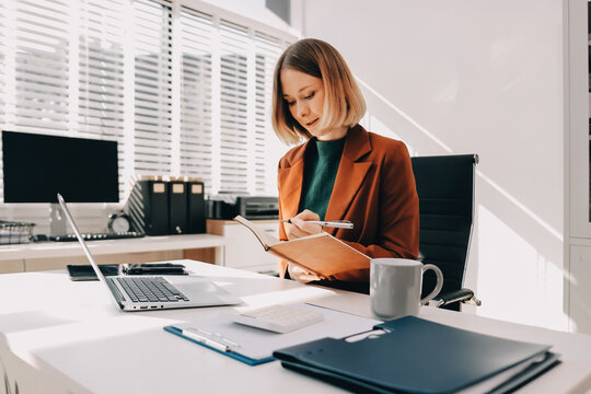 Woman smiling to herself as she works in an office