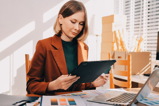 Logistics, small business woman with checklist for stock, clothes order or retail inventory management. Shipping, writing or person at ecommerce startup store for sme delivery with fashion designer