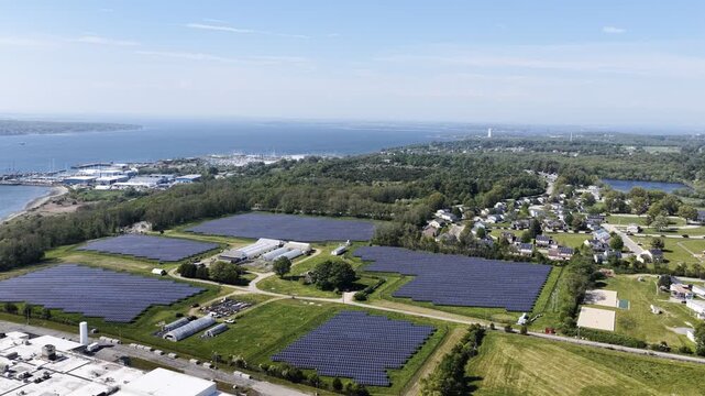 Aerial view of solar farm beside a residential neighborhood in Portsmouth, Rhode Island, USA. Sustainable energy. g.