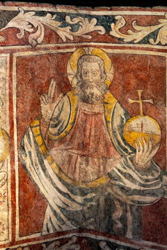 Twelfth‑century fresco depicting God blessing and holding a globus cruciger symbolizing the world.