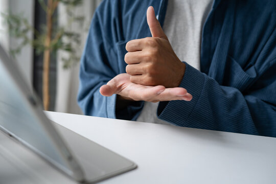 Close up of man using sign language for ASL for accessible online learning and virtual communication.