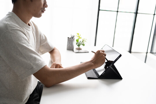 Using stylus on tablet for digital note taking and productivity technology concept.