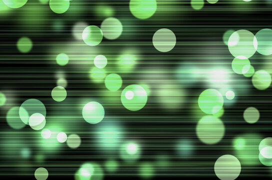 Soft green floating bokeh light circles with horizontal motion blur and ethereal glow