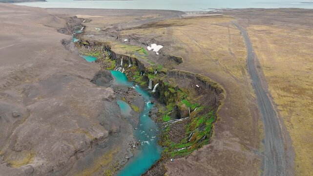 Aerial panorama of Sigoldugljufur canyon and turquoise river in Iceland, drone establishing ascend