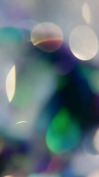 A Close-Up Exploration of Shimmering Lights: An Artistic Study of Blurred Reflections and Soft Bokeh in a Dreamlike Palette of Colors