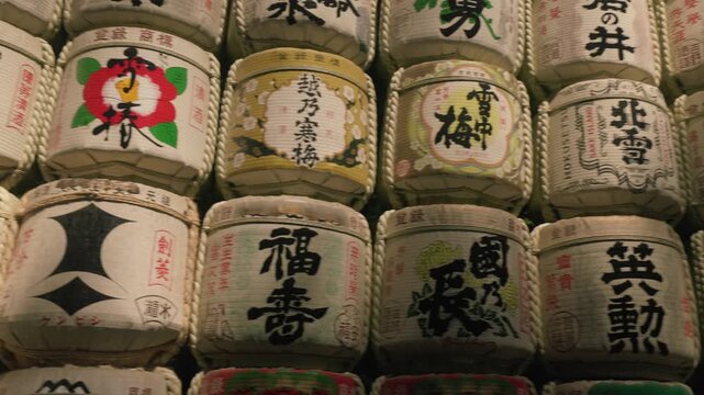Decorative walls of Komodaru sake barrels at Meiji Jingu Shrine in Tokyo, Japan, displaying traditional Japanese sake containers
