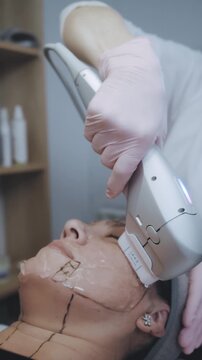 Aesthetic Professional Performing Targeted Facial Rejuvenation With Handheld Device in Clinical Setting
