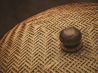 Traditional woven bamboo food cover with a wooden handle in warm tone © Win Nondakowit