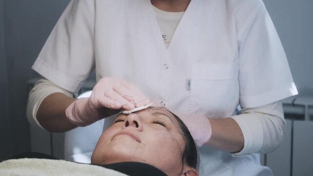 Aesthetic Technician Delivering Methodical Facial Massage and Skincare Treatment During Wellness Session