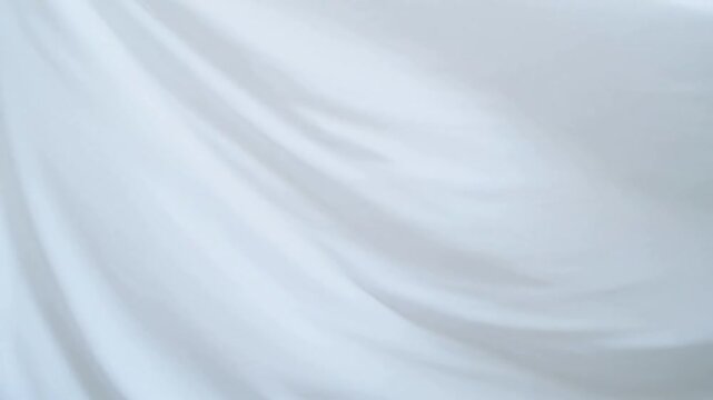 Gentle white fabric draping with soft folds and subtle light shadows