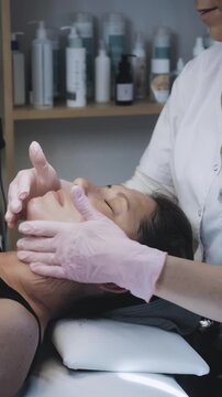 Therapist Applying Gentle Handheld Facial Treatment in Modern Aesthetic Clinic