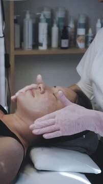Esthetician Providing Professional Facial Treatment With Manual Massage Techniques in Modern Aesthetic Clinic