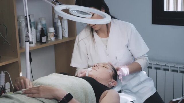 Esthetician Performing Focused Facial Massage and Skincare Application During Aesthetic Treatment Session