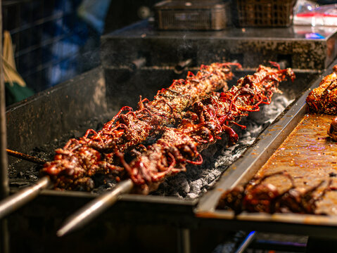 Charcoal Grilled Quail Skewers with Spicy Glaze Close Up Thai Street Food
