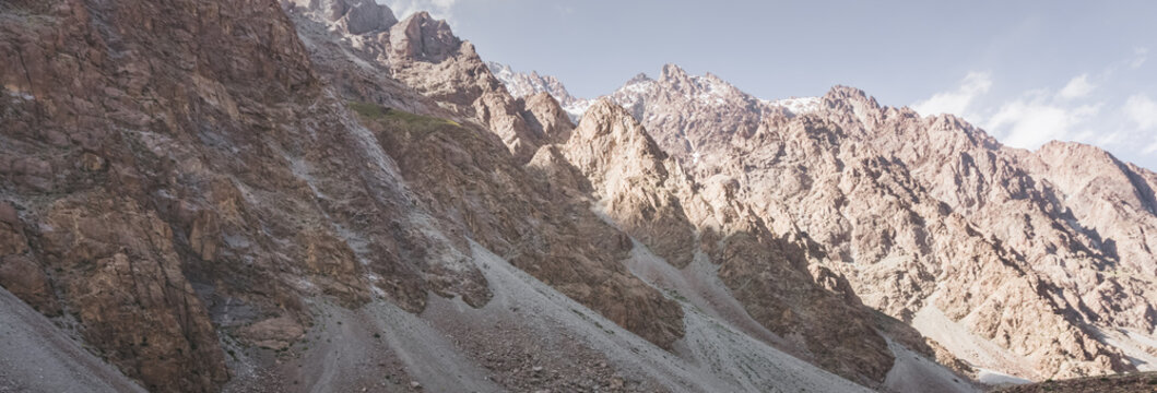 Rocky mountain slopes in the Pamir Mountains in Tajikistan, a minimalist landscape and rocky hills in sunny weather